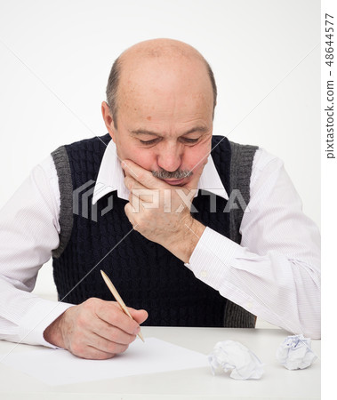 Elderly man writes, draws something Elderly man writes, draws something 48644577