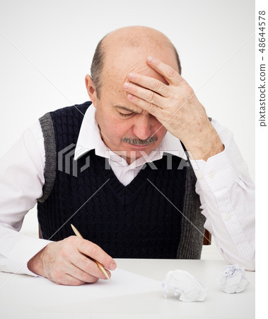 Elderly man writes, draws something Elderly man writes, draws something 48644578