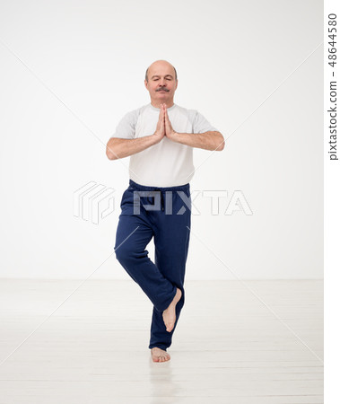 Elderly man practicing yoga or fitness. Elderly man practicing yoga or fitness. 48644580