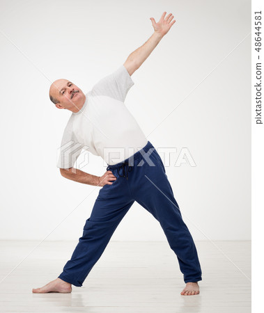 Elderly man practicing yoga or fitness. Elderly man practicing yoga or fitness. 48644581