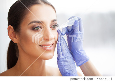 Health and Beauty. Eye Care. Beautiful Young Woman Holding Drops For Eyes. Good Vision. Happy Girl 48645081