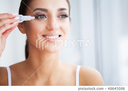 Health and Beauty. Eye Care. Beautiful Young Woman Holding Drops For Eyes. Good Vision. Happy Girl 48645086