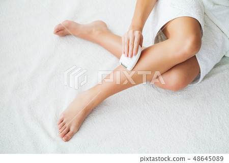 Skin care. Woman shaving her legs in bathroom 48645089