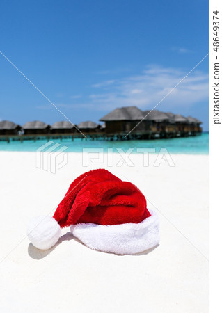 Santa hat on chair with water lodges on background Santa hat on chair with water lodges on background 48649374