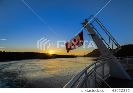 Canadian flag on a ferry at sunset 48652875