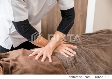 A woman receiving alignment (spine) A woman receiving alignment (spine) 48654908