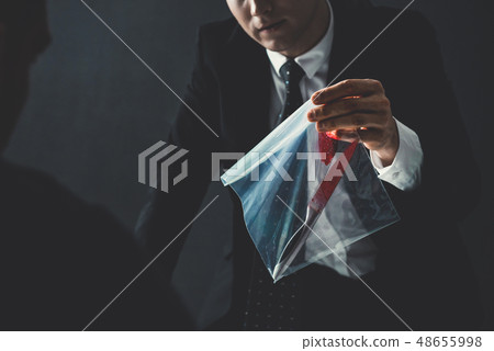 Officer showing an evidence in crime investigation Officer showing an evidence in crime investigation 48655998