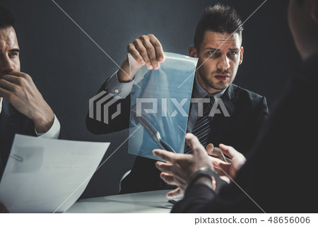 Officer in interrogation room showing a knife as a 48656006