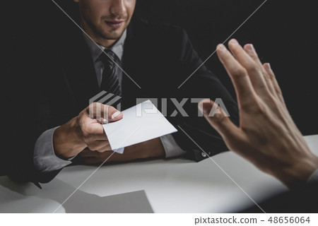 Businessman rejecting money in white envelope 48656064