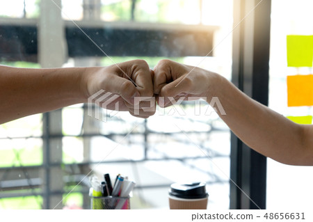 two business man use hand to fist bump for succes two business man use hand to fist bump for succes 48656631