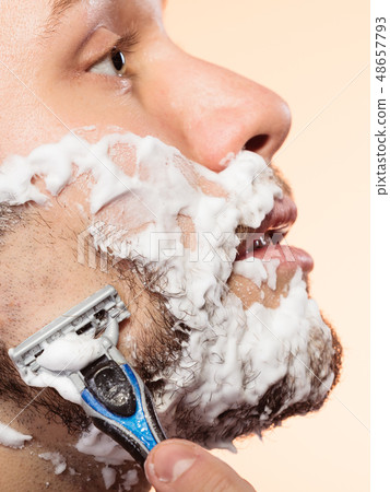 Man shaving with razor Man shaving with razor 48657793