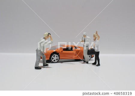 small figure with the toy sport car 48658319