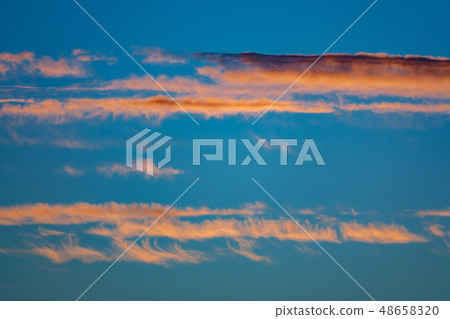 Orange clouds and bluish sky at dusk 48658320