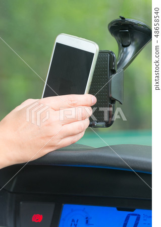 Inserting smart phone into the car holder 48658540