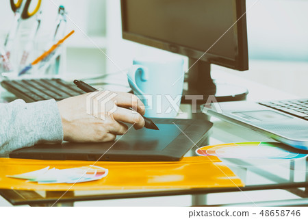 Designer using graphics tablet Designer using graphics tablet 48658746