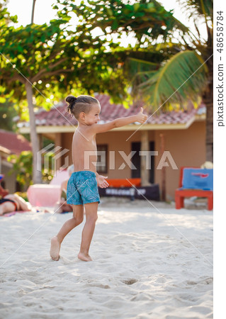 Boy playing Frisbee on the beach  48658784