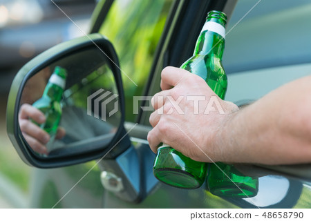Man drinking beer in a car Man drinking beer in a car 48658790