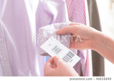 Woman's hands with a barcode label 48658849