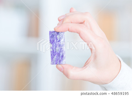 Real charoite in hand 48659195