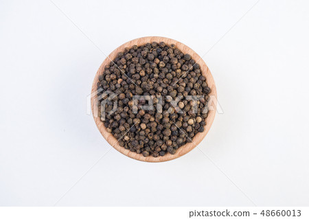 Black pepper peppercorns in wooden bowl isolated Black pepper peppercorns in wooden bowl isolated 48660013