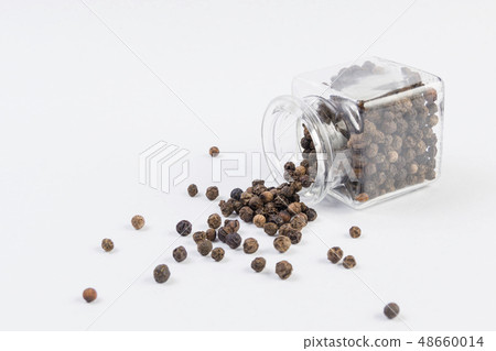 Black pepper peppercorns in a glass jar isolated Black pepper peppercorns in a glass jar isolated 48660014