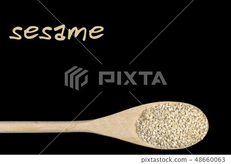 sesame seeds on wooden spoon isolated on black sesame seeds on wooden spoon isolated on black 48660063