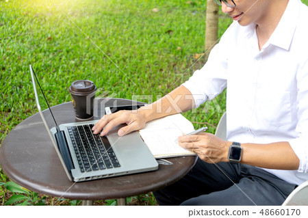 young buseness man work on the table with laptop young buseness man work on the table with laptop 48660170