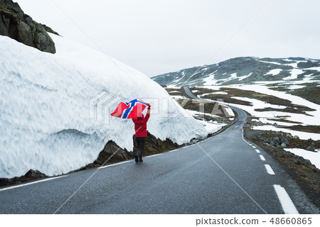 Girl with a Norwegian flag on a mountain road in Girl with a Norwegian flag on a mountain road in 48660865