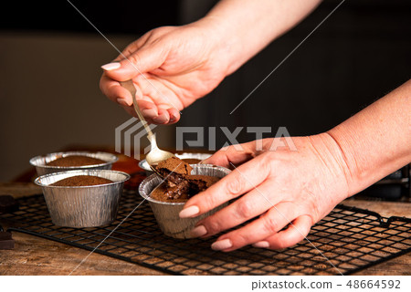 Person eating molten chocolate cake 48664592