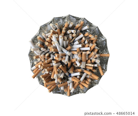 Many cigarette overflowing a glass ashtray. Many cigarette overflowing a glass ashtray. 48665014