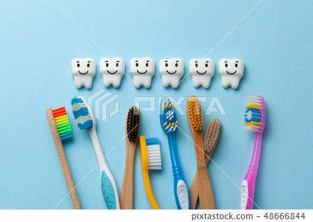 Healthy white teeth are smiling on blue background with toothbrush 48666844