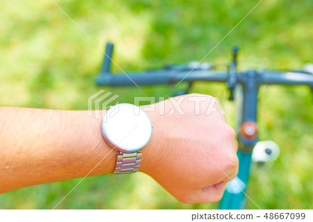 Man with smart watches on a bike 48667099