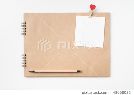 kraft notebook, photo frame and pen on white kraft notebook, photo frame and pen on white 48668025
