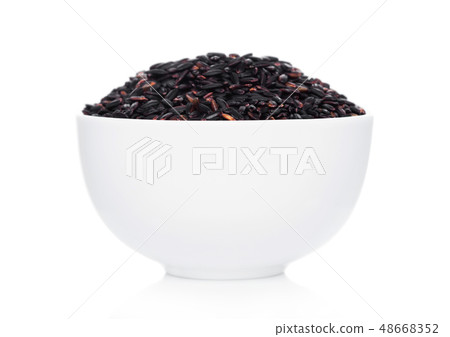 White bowl of raw organic black venus rice on White bowl of raw organic black venus rice on 48668352