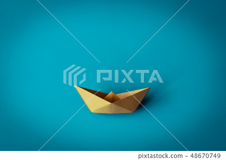 yellow paper boat on bright background 48670749