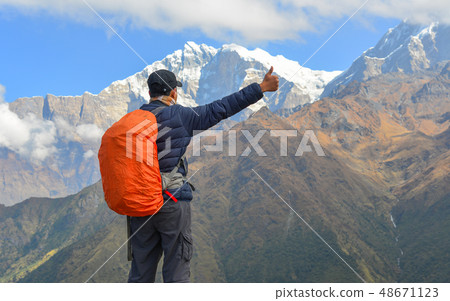 Young trekker looking at snow mountain 48671123