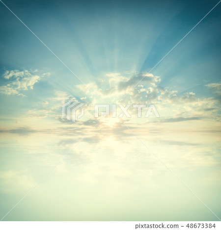 Sky with clouds and sun reflection in water 48673384