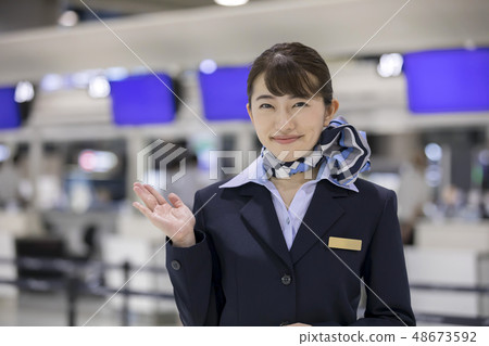 Cabin attendant at check-in counter 48673592