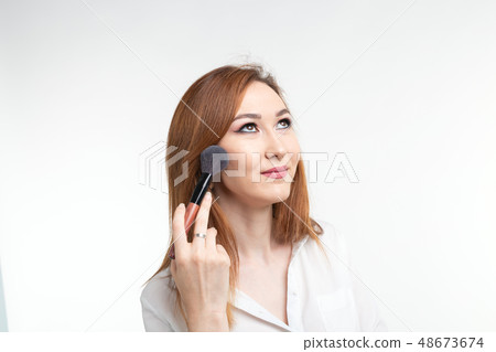 Beauty makeup artist. Close Up korean beautiful young woman pretty smiling holding make-up brushes Beauty makeup artist. Close Up korean beautiful young woman pretty smiling holding make-up brushes 48673674
