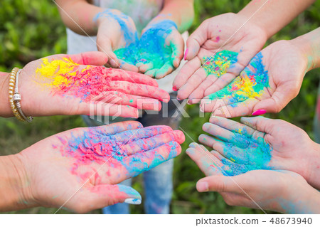 Indian holidays, fun and Holi festival concept - Female palms covered in different colors Indian holidays, fun and Holi festival concept - Female palms covered in different colors 48673940