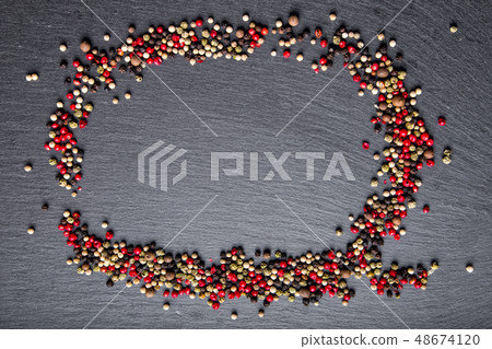 pepper scattered on slate, top view pepper scattered on slate, top view 48674120