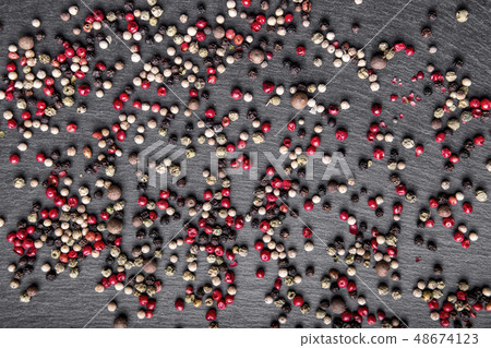 pepper scattered on the slate. top view pepper scattered on the slate. top view 48674123