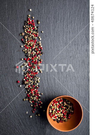 pepper on a slate board pepper on a slate board 48674124