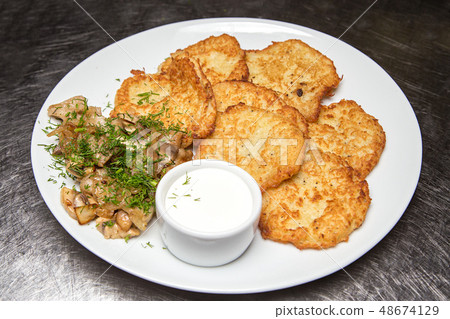 potato pancakes with sour cream potato pancakes with sour cream 48674129