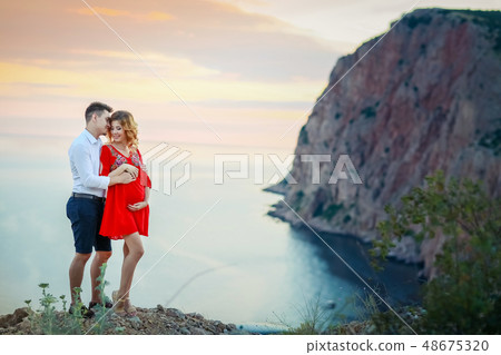 Couple family traveling together on cliff edge in Norway man and woman lifestyle concept summer Couple family traveling together on cliff edge in Norway man and woman lifestyle concept summer 48675320