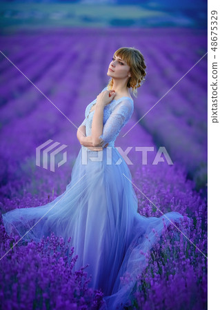 Beautiful Bride in wedding day in lavender field. Newlywed woman in lavender flowers. Beautiful Bride in wedding day in lavender field. Newlywed woman in lavender flowers. 48675329