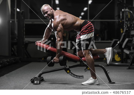 Handsome strong bodybuilder athletic men pumping Handsome strong bodybuilder athletic men pumping 48676537