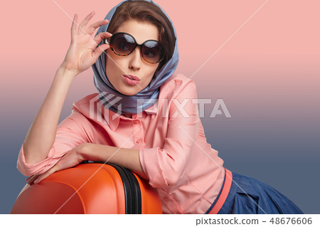 Elegant woman with a suitcase travel Elegant woman with a suitcase travel 48676606