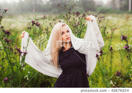 Portrait of young girl dancing in chamomile field Portrait of young girl dancing in chamomile field 48676854