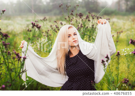 Portrait of young girl dancing in chamomile field 48676855